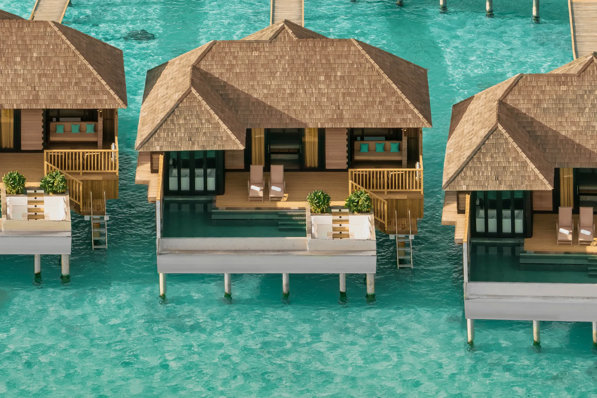 Aerial view of a horizon water villa with private pool over the lagoon at Sun Siyam Iru Fushi, Maldives