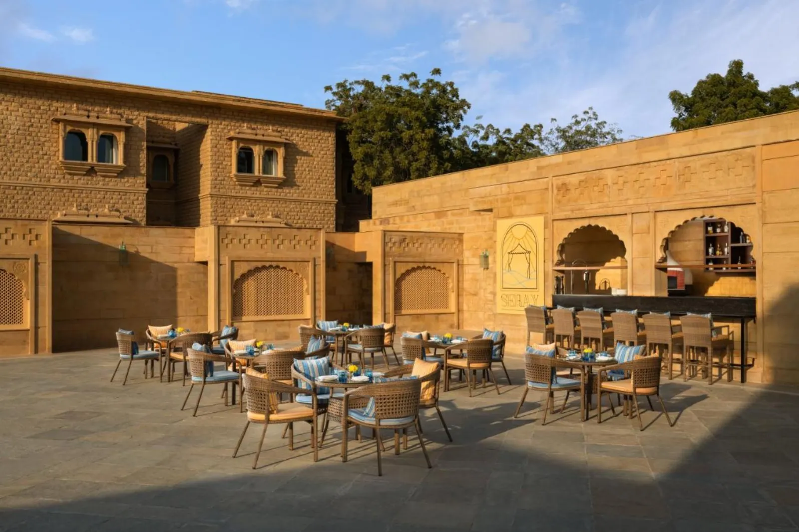 Taj Gorbandh Palace golden-sandstone palace-hotel glowing above its lawns at the edge of the Thar Desert, Jaisalmer