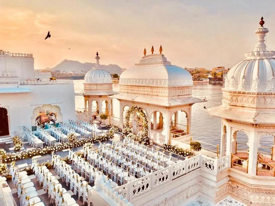 Rooftop reception setting at Taj Lake Palace with the Udaipur City Palace skyline