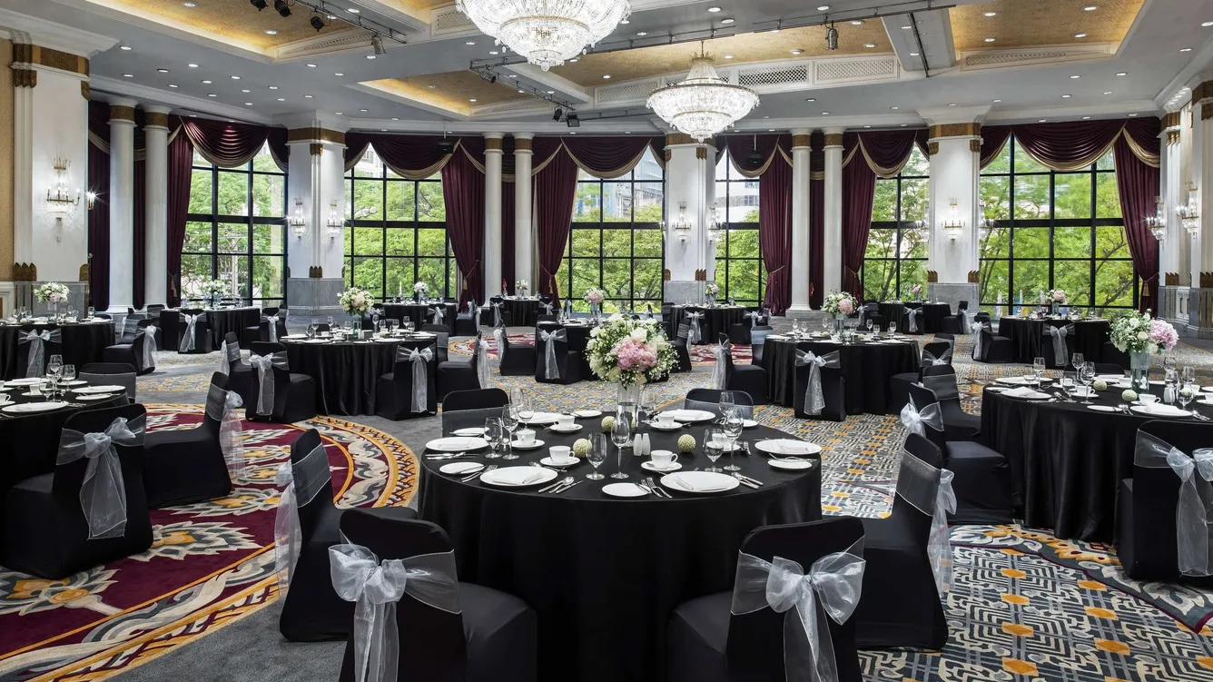 Pillarless ballroom set with round tables for a banquet dinner at The Athenee Hotel Bangkok