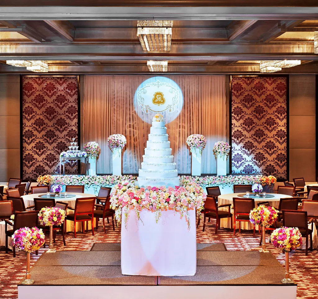 Astor Ballroom at The St. Regis Bangkok set with round tables for a wedding banquet