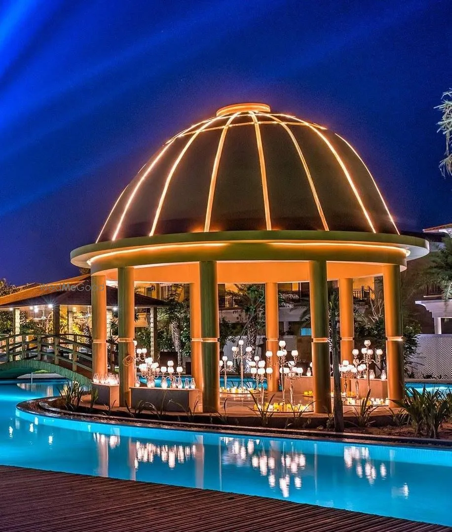 Illuminated domed pavilion candle-lit over the lagoon-style pool at night, The Westin Pushkar Resort & Spa