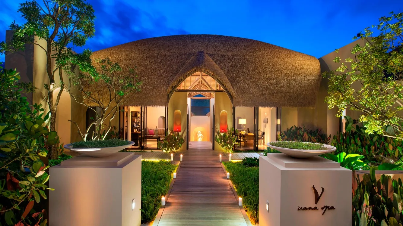 Vana Belle Luxury Collection resort hillside cove and Chaweng Noi Beach glowing at dusk, Koh Samui